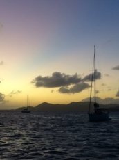 boats sailing the uk virgin islands at sunset