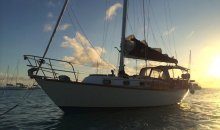 boats cruising the british virgin islands at sunset